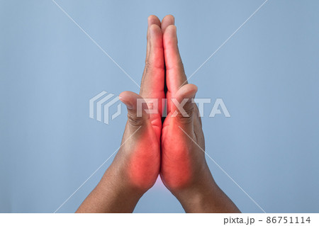 Office syndrome concept. Fingers are massaged after working. Pain symptom area is shown with red color. Close up shot isolates on blue background. Office syndrome concept. Fingers are massaged after working. Pain symptom area is shown with red color. Close up shot isolates on blue background. 86751114