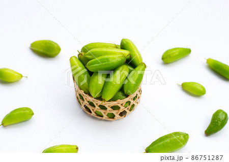 Bilimbi fruit in bamboo basket on white background. 86751287