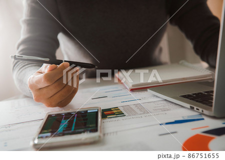 Businesswoman analyze business report graph and finance chart at corporate office. Concept of finance economy, banking business and stock market research. 86751655