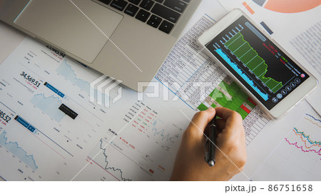 Businesswoman analyze business report graph and finance chart using smartphone and computer laptop at corporate office. Businesswoman analyze business report graph and finance chart using smartphone and computer laptop at corporate office. 86751658