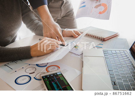 Business team analyzing sales data and economic growth graph chart on office table with laptop and smart phone, Brainstorming, Business strategy and planning. Business team analyzing sales data and economic growth graph chart on office table with laptop and smart phone, Brainstorming, Business strategy and planning. 86751662
