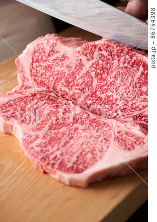 サーロインステーキを包丁でカットする料理人　国産黒毛和牛 86754398