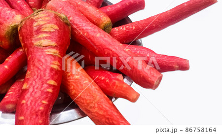 Lots of fresh red and sweet peeled carrots kept in a plate 86758164