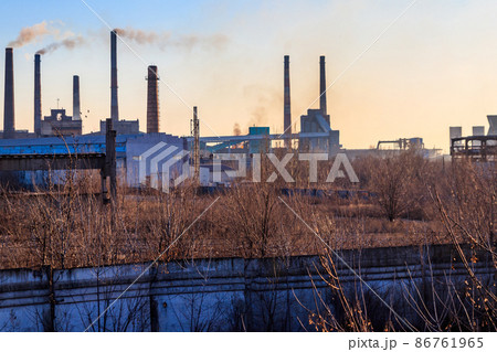 View of old factory with pipes with smoke. Air pollution, environmental damage View of old factory with pipes with smoke. Air pollution, environmental damage 86761965