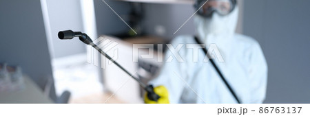 Person in protective suit and mask disinfects kitchen Person in protective suit and mask disinfects kitchen 86763137