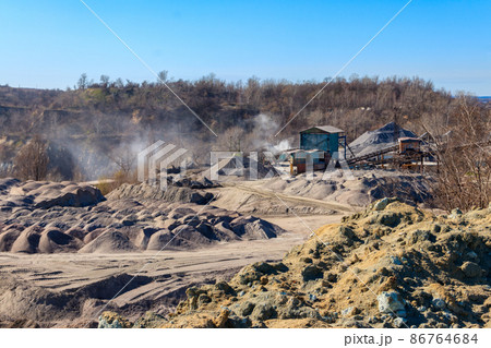 Rock crusher machine, crushing machinery, conveying crushed granite gravel stone in a granite quarry. Processing plant for crushed stone and gravel. Mining equipment Rock crusher machine, crushing machinery, conveying crushed granite gravel stone in a granite quarry. Processing plant for crushed stone and gravel. Mining equipment 86764684