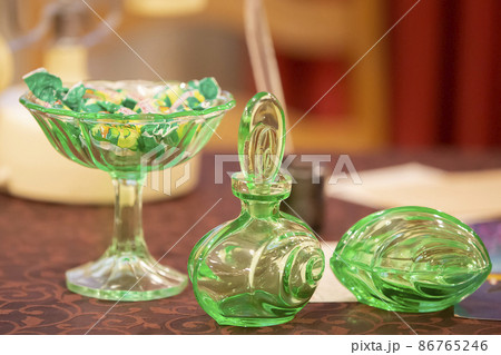 Glassware. Glass green dishes are on the table. Glassware. Glass green dishes are on the table. 86765246