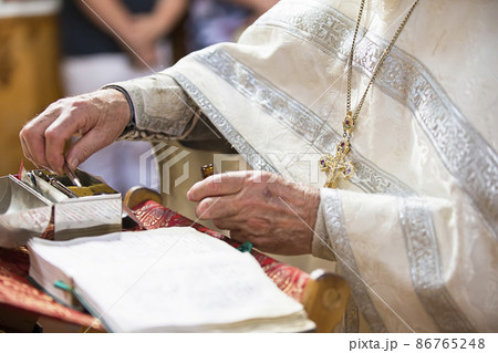 Orthodox religion. Hands of the priest on the bible. Orthodox religion. Hands of the priest on the bible. 86765248