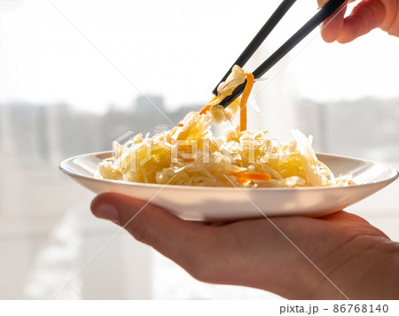 Sauerkraut with vegetable oil in rays of daylight. National european dish Pickled cabbage carrot Homemade fermented food Sauerkraut with vegetable oil in rays of daylight. National european dish Pickled cabbage carrot Homemade fermented food 86768140