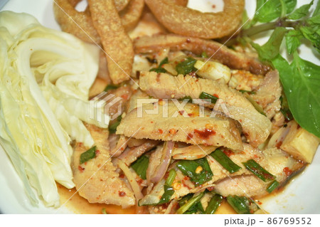 spicy roasted pork Thai salad eat with fresh basil leaf and cabbage on plate 86769552