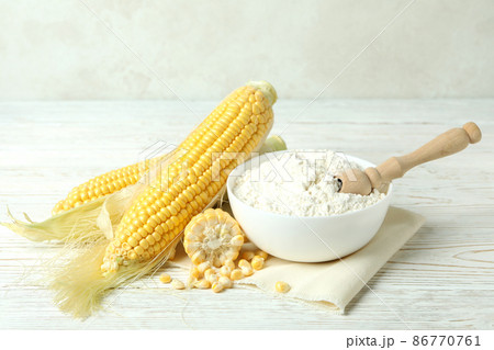 Raw corn and flour on white wooden table Raw corn and flour on white wooden table 86770761