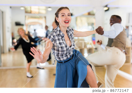 Pair dancing lindy hop during rehearsal Pair dancing lindy hop during rehearsal 86772147