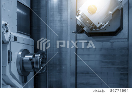 The multi-tasking CNC machine cutting the metal pulley part. The multi-tasking CNC machine cutting the metal pulley part. 86772694