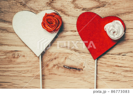red and white hearts with sticks on wooden table background. red and white hearts with sticks on wooden table background. 86773083