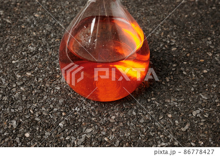 Chemical Orange Flask on Ruberoid Grain Surface 86778427