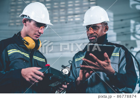 Group of factory job workers using adept machine equipment in a workshop 86778874