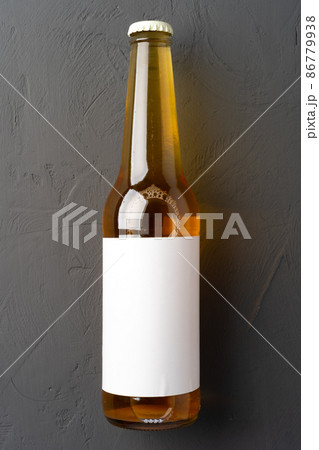 Beer bottle, on gray stone background, top view, with copy space for text 86779938