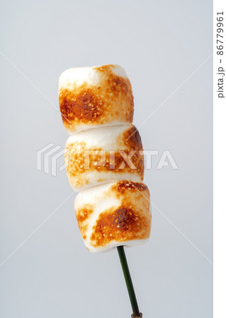 Roasted Marshmallow on a stick, isolated on a white background. Roasted Marshmallow on a stick, isolated on a white background. 86779961