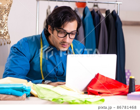 The young male tailor working at workshop 86781468