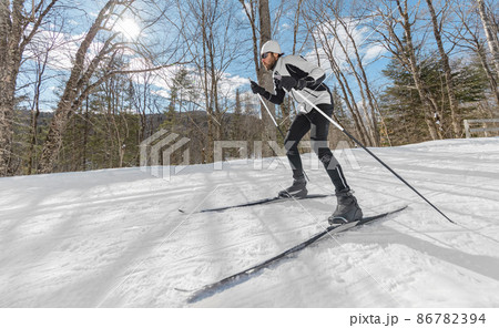 Winter sport. Man Cross Country Skate Skiing Style - Nordic Ski in Forest. Man in winter doing fun endurance winter sport activity in the snow on cross country ski in beautiful nature landscape 86782394