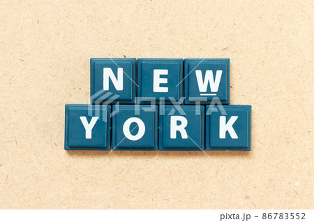 Tile alphabet letter in word new york on wood background 86783552