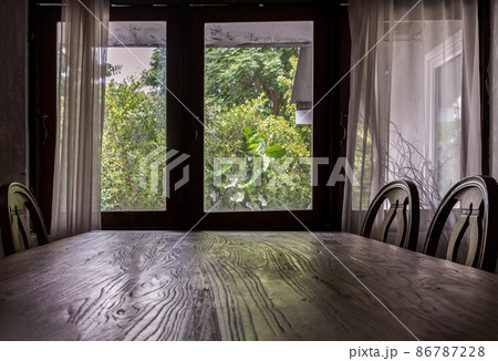 Wooden eating table and chairs in dining room. Wooden eating table and chairs in dining room. 86787228