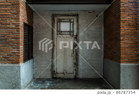 White wooden door on the old red and white brick wall at vintage house. White wooden door on the old red and white brick wall at vintage house. 86787354