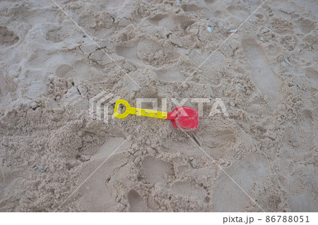 Childrens toy shovel for playing in the sand lies on the beach. Kids toy on the beach. High quality photo 86788051