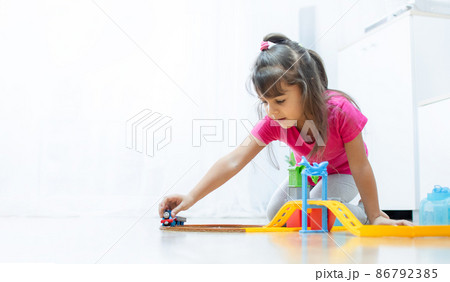 baby game. Little clever caucasian child playing colorful toy railway and train for early development. 86792385