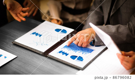 Image of business documents with working team communicating at background 86796082