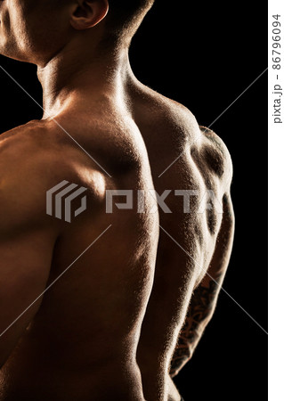 bodybuilder posing. Beautiful sporty guy male power. Fitness muscular body. Isolated on black background bodybuilder posing. Beautiful sporty guy male power. Fitness muscular body. Isolated on black background 86796094