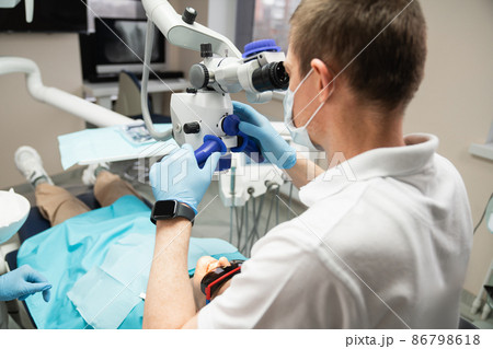 Dentist with dental microscope Dentist with dental microscope 86798618