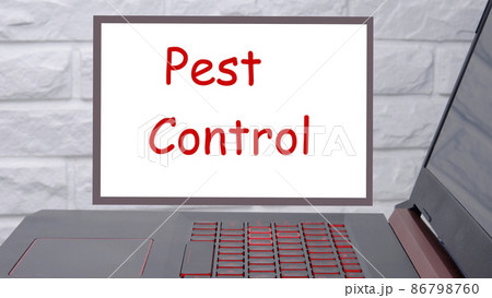 Pest Control a phrase written on a magnetic board next to a laptop with a glowing keyboard Pest Control a phrase written on a magnetic board next to a laptop with a glowing keyboard 86798760
