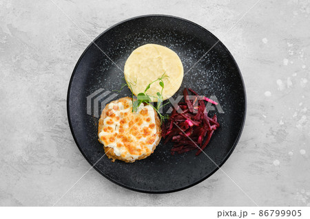 Kiev citlet with mashed potato and pickled beetroot on a plate, top view 86799905
