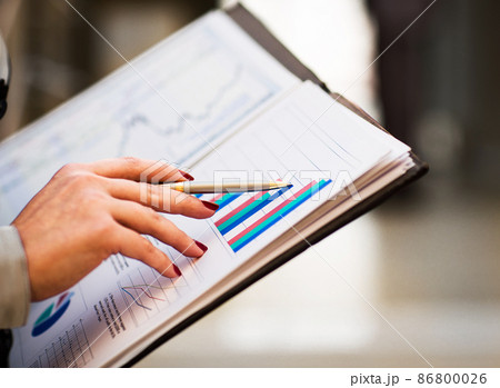 Close-up of female and male hands pointing at business document while discussing it Close-up of female and male hands pointing at business document while discussing it 86800026
