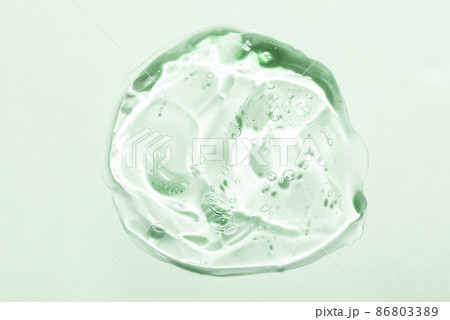 Transparent hyaluronic acid gel drop on a green background. Transparent hyaluronic acid gel drop on a green background. 86803389