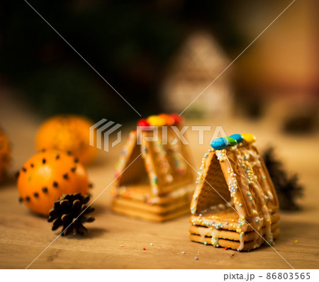 beautiful gingerbread house on wooden background with Christmas decorations 86803565