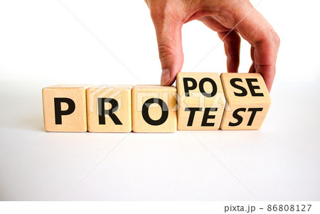 Propose instead protest symbol. Businessman turns wooden cubes, changes the word 'protest' to 'propose'. Beautiful white table, white background. Business, protest or propose concept. Copy space. Propose instead protest symbol. Businessman turns wooden cubes, changes the word 'protest' to 'propose'. Beautiful white table, white background. Business, protest or propose concept. Copy space. 86808127
