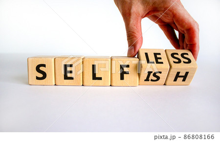 Selfish or selfless symbol. Businessman turns cubes and changes the word 'selfish' to 'selfless'. Beautiful white background, copy space. Business, psuchological and selfish or selfless concept. 86808166