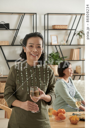 Elderly Woman Attending House Party Elderly Woman Attending House Party 86808234