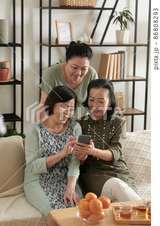 Senior Friends Watching Funny Videos Senior Friends Watching Funny Videos 86808293