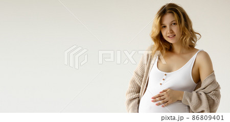 Woman standing and touching with hands her big 86809401