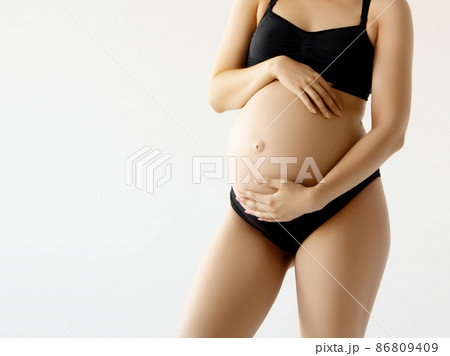 Woman standing and touching with hands her naked 86809409