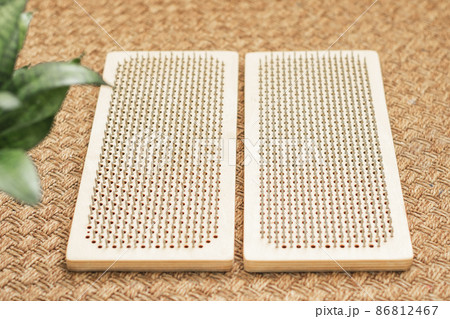 Sadhu board with nails lies on the floor, preparing for exercises. Practice standing on nails at home 86812467