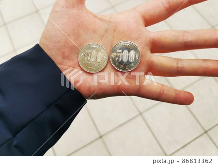 手のひらにある500円玉 86813362