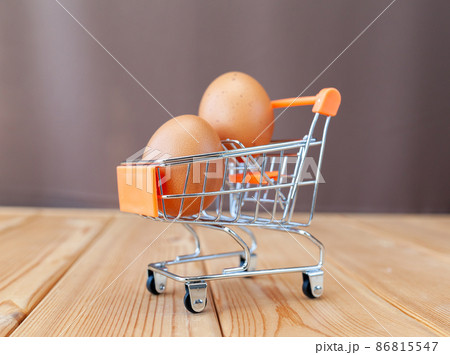 A few brown eggs among the cells of a large cardboard bag, a chicken egg as a valuable nutritious product, a tray for carrying and storing fragile eggs. A full package of eggs, an important food item 86815547