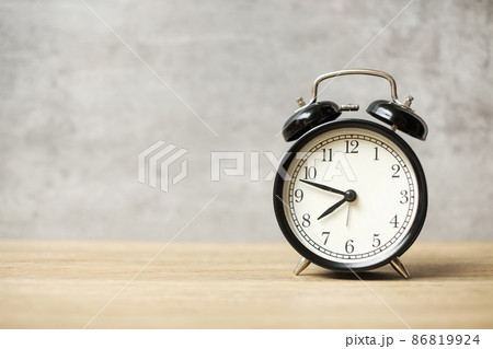 Vintage alarm clock on wooden table background and copy space for text. Activity, daily routine, morning, workout and Work life balance concept 86819924