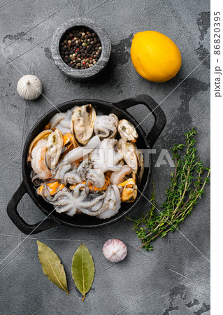 Raw seafood mussels, squid octopus, on gray stone table background, top view flat lay Raw seafood mussels, squid octopus, on gray stone table background, top view flat lay 86820395