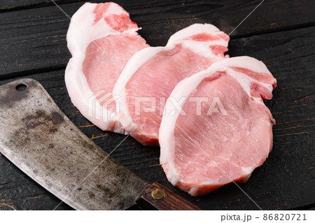 Raw pork ham cut, on black wooden table background Raw pork ham cut, on black wooden table background 86820721