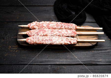Raw shish kebab skewers, on black wooden table background, with copy space for text Raw shish kebab skewers, on black wooden table background, with copy space for text 86820874